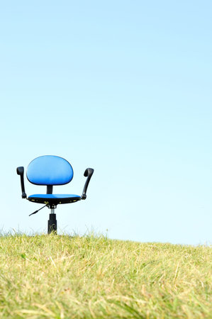 Empty seat on hill with skyの写真素材