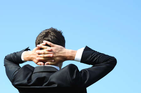 Business man relaxing on sky