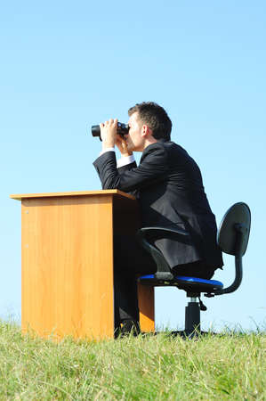 Business man at desk in natureの写真素材