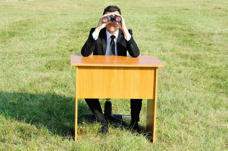 Business man at desk in natureの写真素材