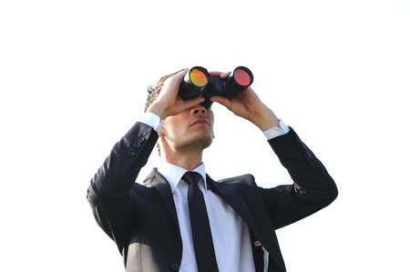 Business man looking with binoculars の写真素材