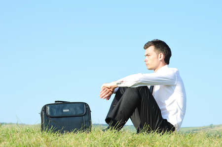 Business man standing upset in natureの写真素材