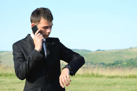 Business man with phone in natureの写真素材
