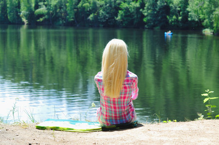 Young girl stand at lakeの写真素材
