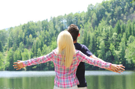 Young couple freedom at lakeの写真素材