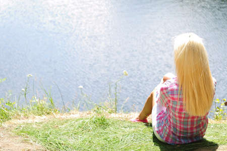 Young girl stand at lakeの写真素材