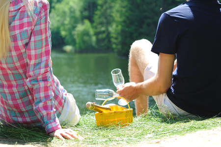 Young couple celebrating at lakeの写真素材