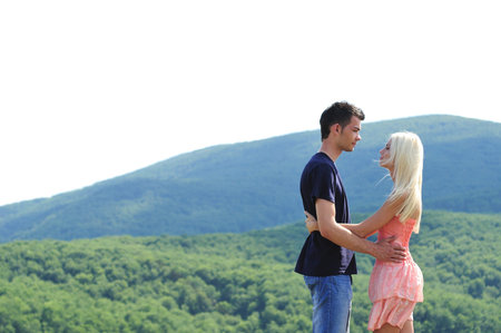 Young couple hugging in nature