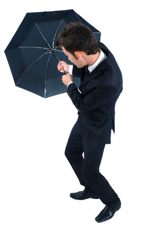 Isolated young business man with umbrellaの写真素材