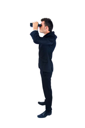 Isolated young business man with binocularの写真素材