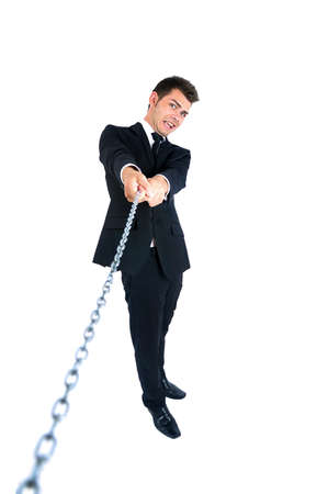Isolated young business man pull chainの写真素材