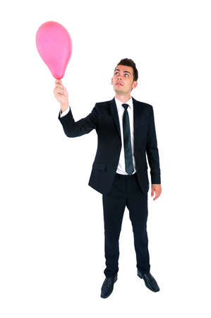 Isolated young business man with balloonの写真素材