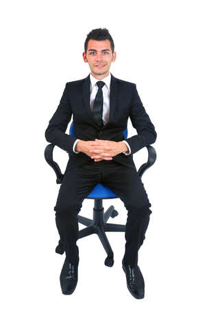 Isolated young business man standing on chairの写真素材