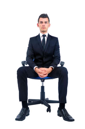 Isolated young business man standing on chairの写真素材