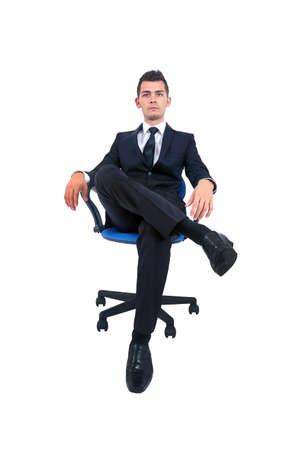 Isolated young business man standing on chairの写真素材