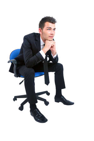Isolated young business man on chairの写真素材