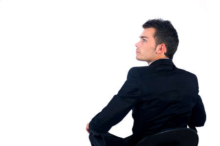 Isolated young business man sitting on chairの写真素材
