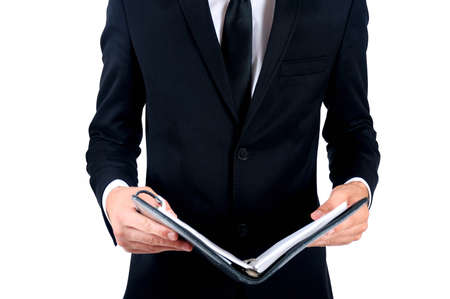 Isolated business man standing with notebookの写真素材