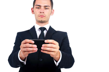 Isolated young business man with phoneの写真素材