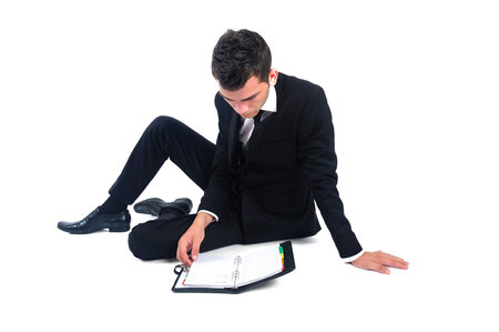 Isolated business man with agendaの写真素材