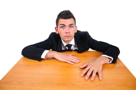 Isolated business man at confuse desk の写真素材