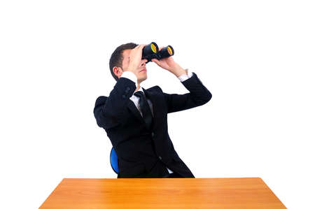 Isolated business man with binocular at desk の写真素材