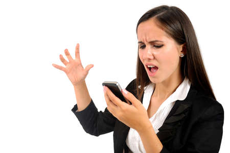 Isolated young business woman screaming at phoneの写真素材