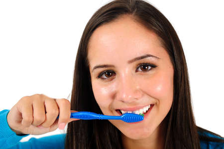 Isolated young casual girl cleaning teethの写真素材