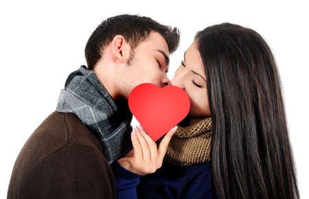Isolated young casual couple kissingの写真素材