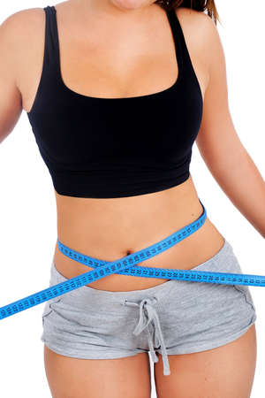 Isolated young fitness woman measureの写真素材