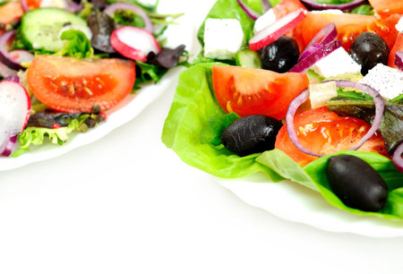 Plate with salad on white