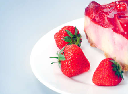 Cake with strawberry on blue background の写真素材