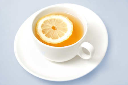 Cup of tea with lemon on blue background の写真素材
