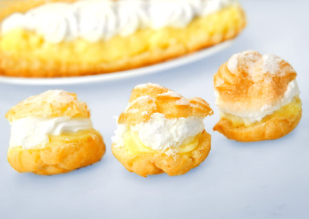 Eclair and minichoux on blue background 
