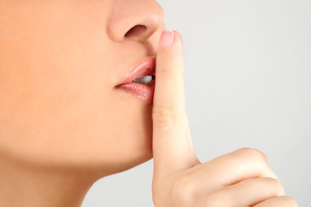 Woman showing finger hush sign