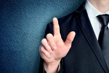 Business man pressing imaginary buttonの写真素材