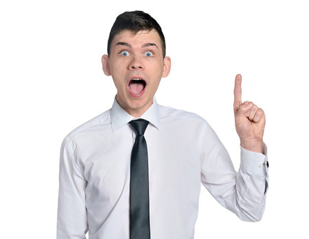 Business man amazed pointing upの写真素材