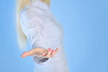 Woman giving empty hand to cameraの写真素材