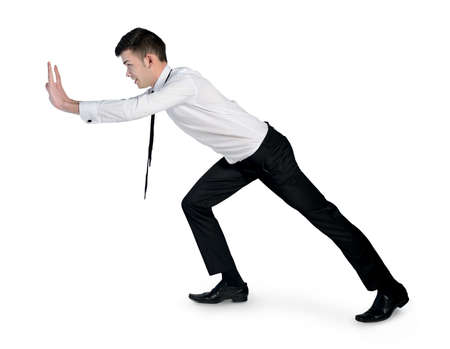 Isolated business man pushing somethingの写真素材