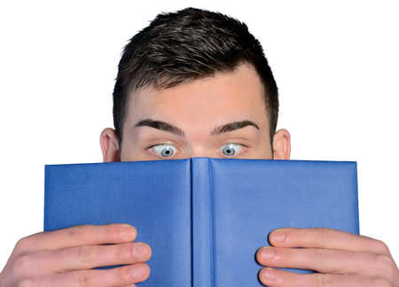 Man reading book with big eyesの写真素材