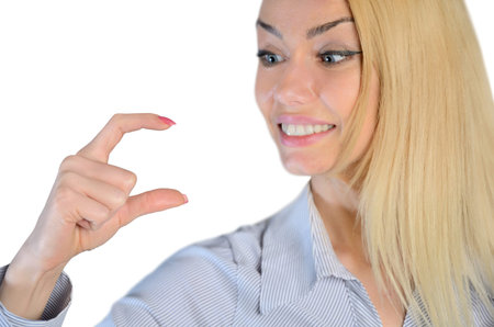 Isolated woman holding something in fingersの写真素材