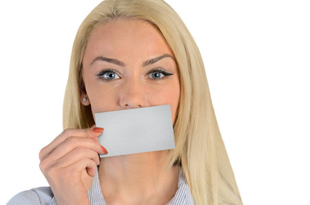 Isolated business woman cover lips with cardの写真素材