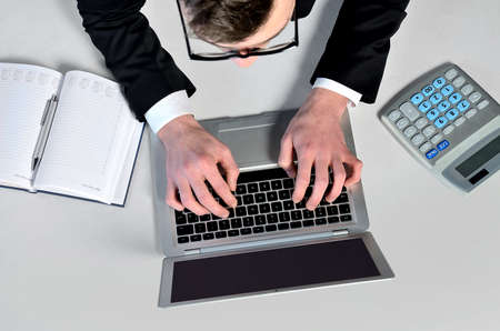 Business man writing at laptopの写真素材