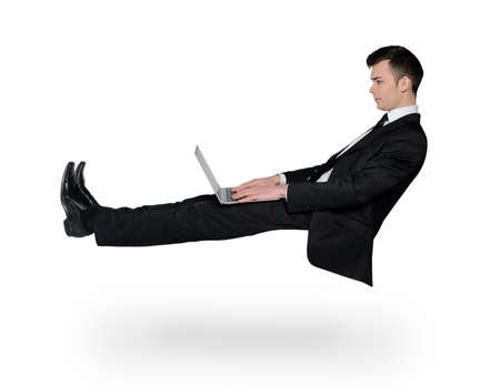 Isolated business man typing laptopの写真素材