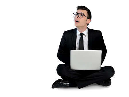 Isolated business man surprised with laptopの写真素材