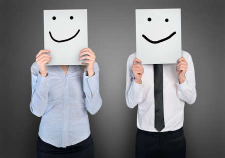 Smile shape on paper in ahnds of business womana nd manの写真素材