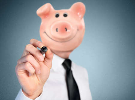 Isolated business man with piggy bank headの写真素材