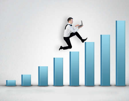 Business man climb blue bar stairs with laptop in handの写真素材