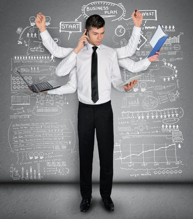 Young business man multitasking conceptの写真素材