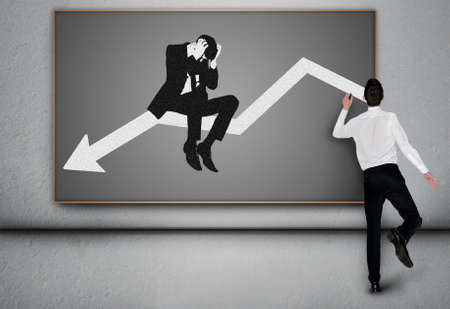 Young business man write down arrow on blackboardの写真素材